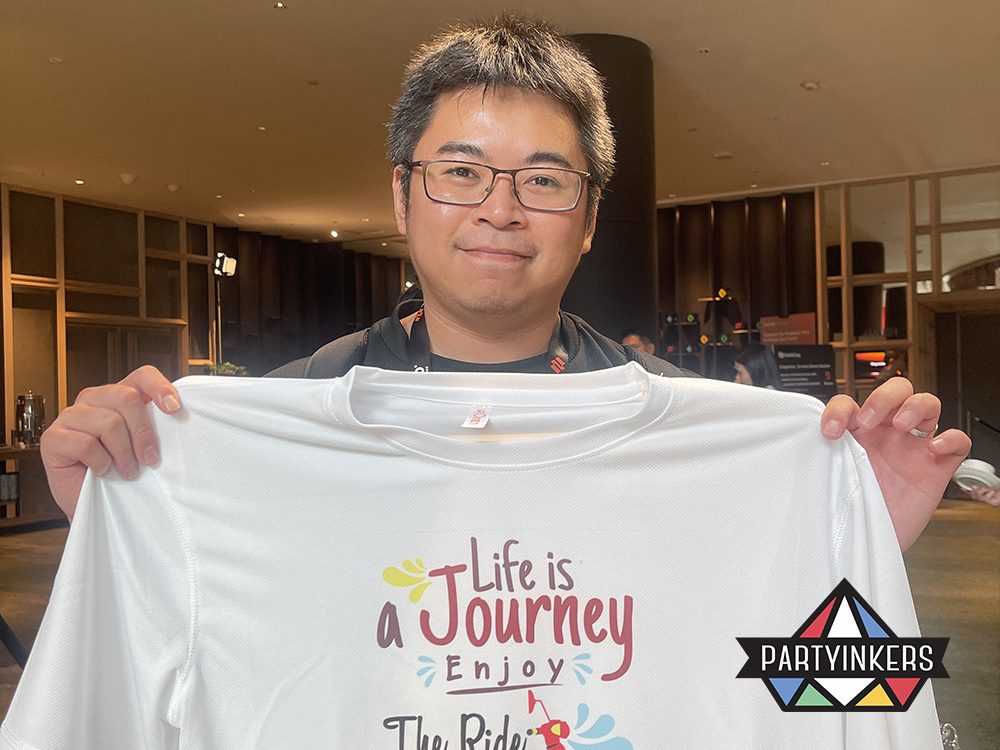 attendees proudly displaying their custom-printed t-shirts with personalized designs, created using Partyinkers' live printing service at a conference