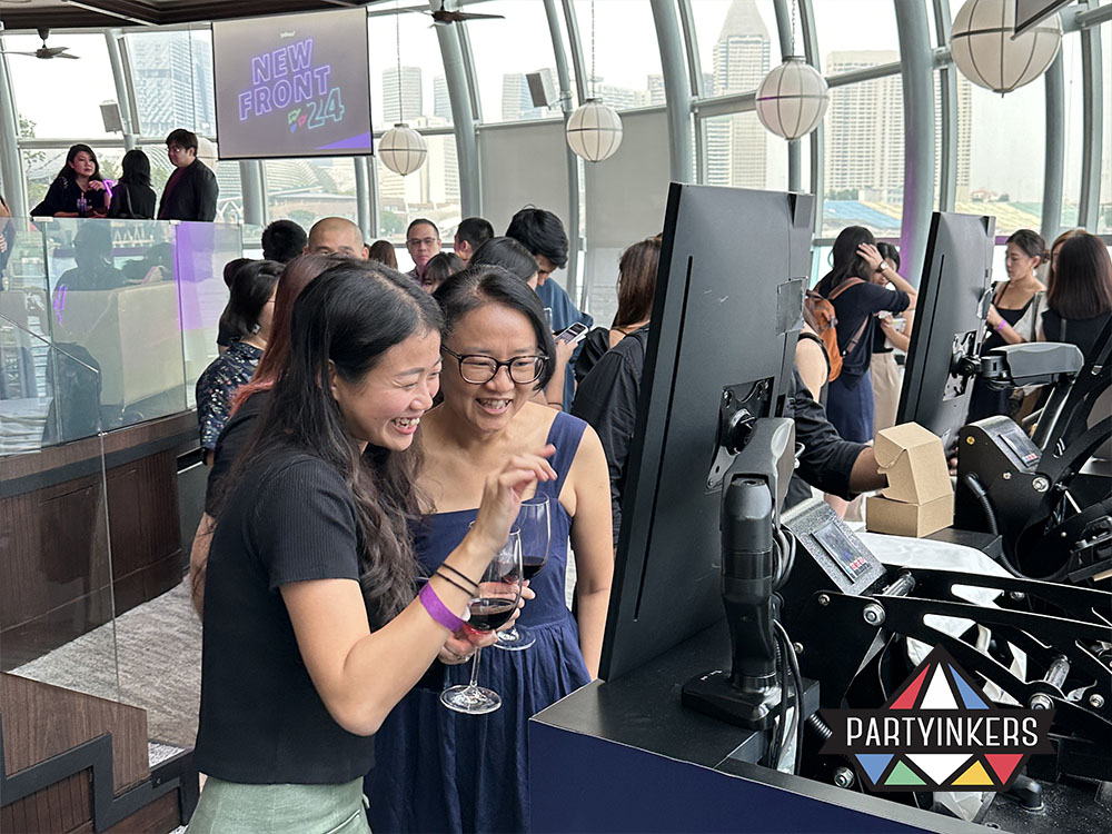 Attendees using touchscreen kiosks to design their personalized tote bags as conference gifts for attendees.