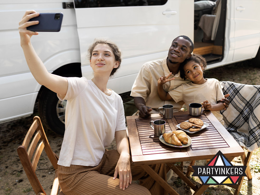 A family enjoying a picnic together at a corporate family day activities, with pastries and coffee on the table, capturing the relaxed and enjoyable atmosphere of the food truck and picnic area.