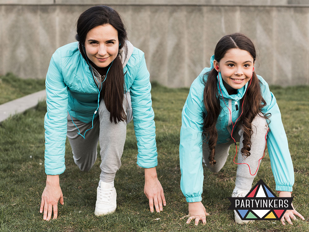 A mother and daughter in matching athletic outfits, preparing to race together during a team-building activity at a corporate family day event, showcasing teamwork and fun.