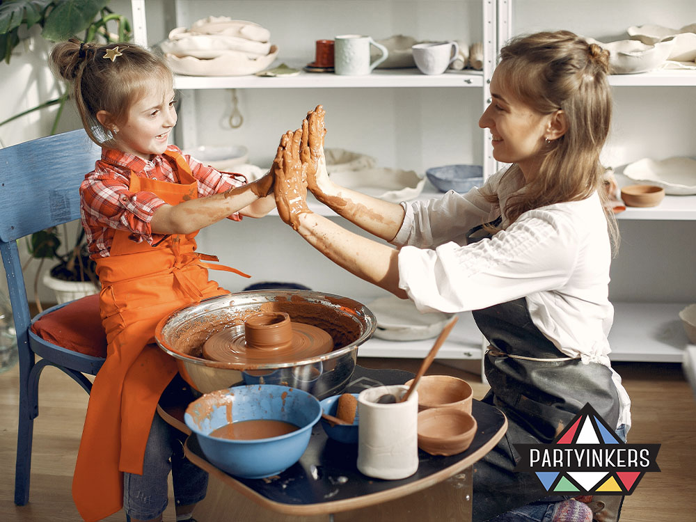 A mother and daughter happily participating in a pottery workshop during a corporate family day activities, engaging in hands-on creative activities to foster creativity and bonding
