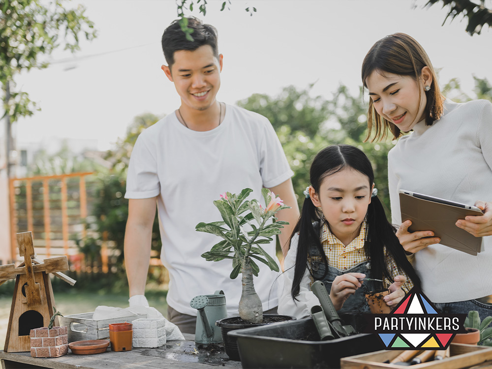 A family participating in an eco-friendly planting activity at a corporate family day activities, focusing on sustainability, with a young girl potting a plant while parents assist and observe.