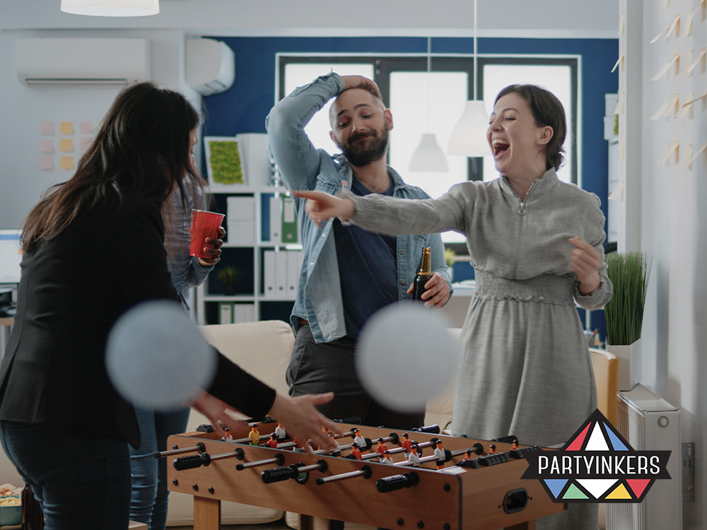 Attendees enjoying a lively foosball game during an event, fostering excitement and engagement. Incorporating fun activities like games helps keep energy levels high and encourages interaction, enhancing overall event engagement.