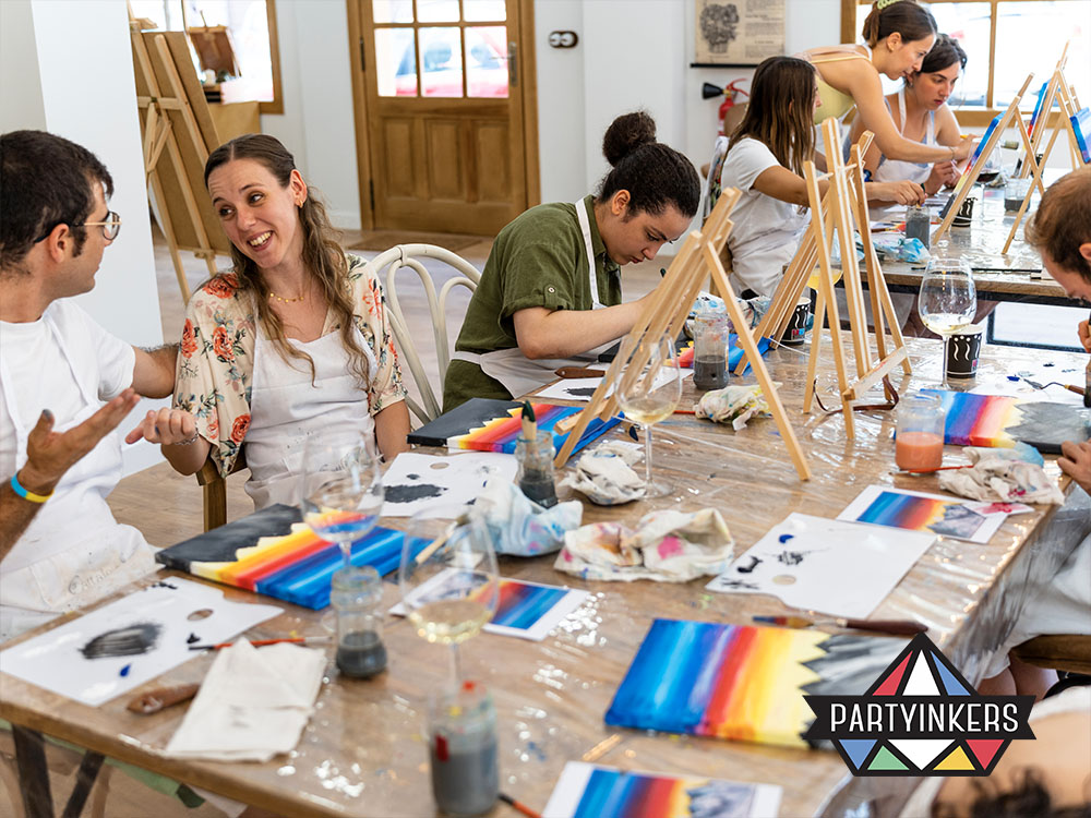 Attendees at a DIY craft station enjoying a painting activity, engaging in creative hands-on experiences that foster interaction and personalization, highlighting the appeal of DIY craft stations as interactive booth ideas.