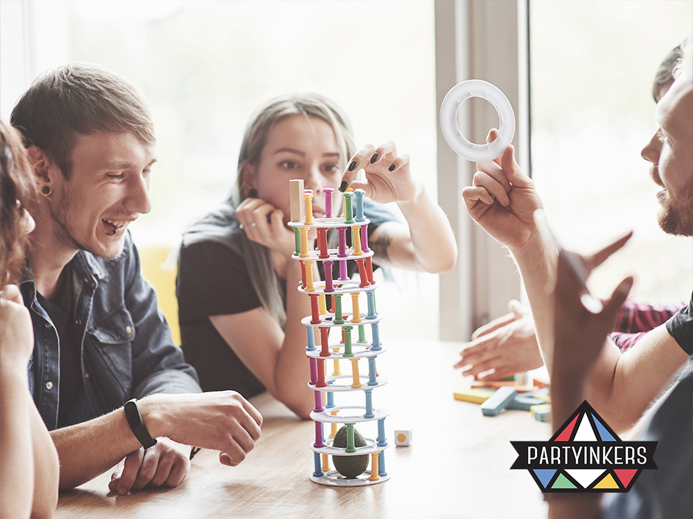 A group of attendees enjoying a fun and engaging stacking game which one of the interactive booth ideas, demonstrating how interactive games can create excitement and boost engagement at events.