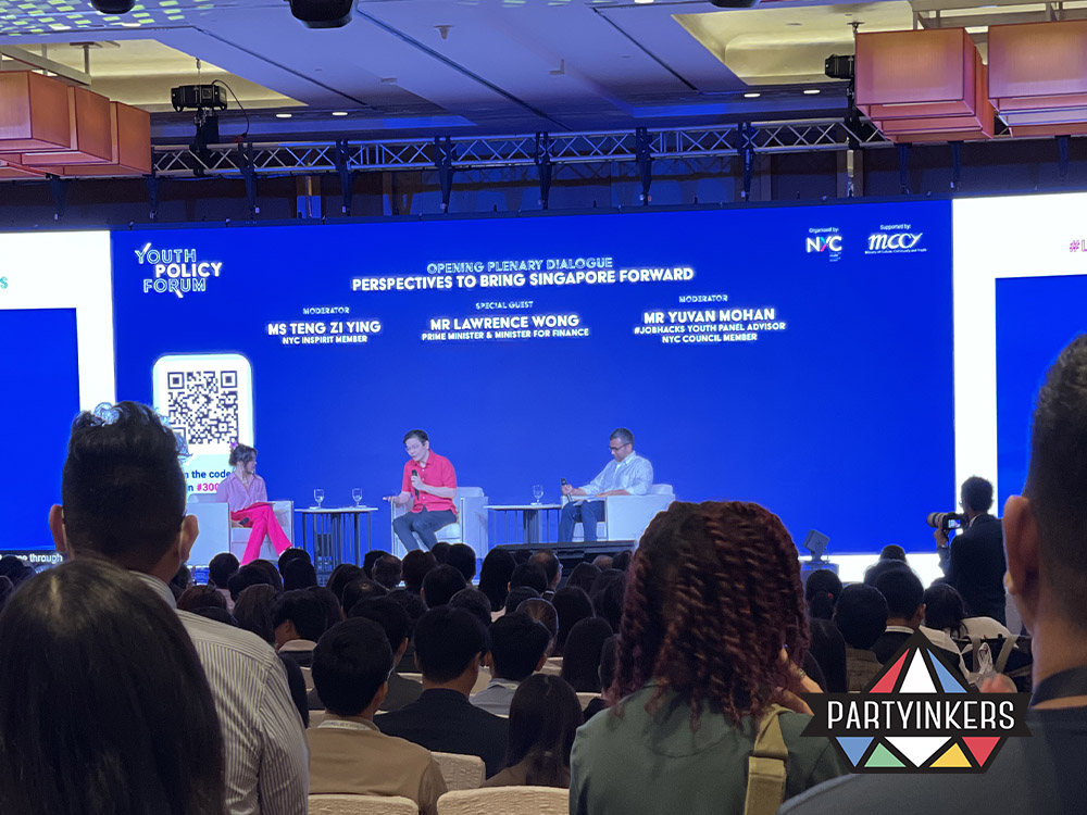 A panel discussion at the Youth Policy Forum, featuring industry experts speaking on stage in front of a large audience. The setup illustrates how inviting industry experts to your booth for live talks, Q&A sessions, or panels can attract crowds and position your brand as a leader in the field. This approach creates an opportunity for meaningful engagement with attendees while providing them valuable insights and knowledge.