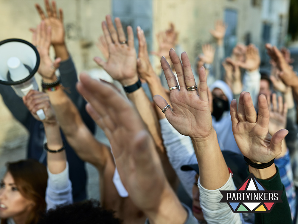 A group of attendees raising their hands in participation during an outdoor event, highlighting one of the interactive event ideas where audience involvement and active engagement are encouraged through collective activities.