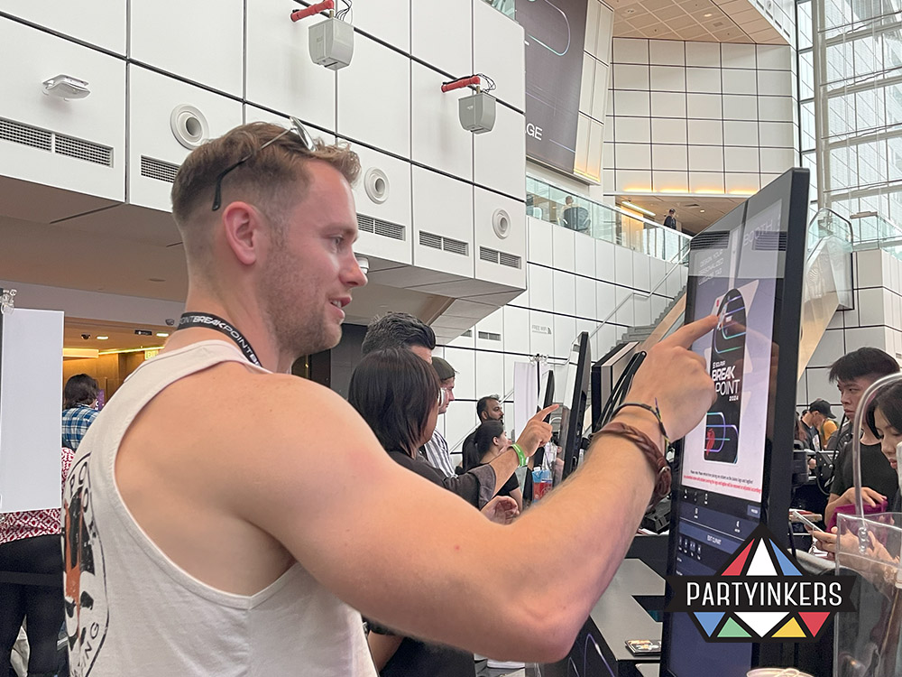 An attendee interacting with a touchscreen kiosk at an event, selecting designs for personalized products, highlighting one of the interactive event ideas that encourages engagement through hands-on digital customization.
