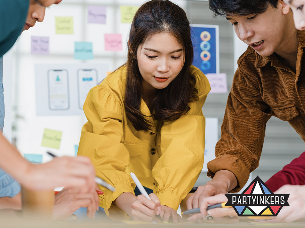 A group of attendees actively participating in a hands-on workshop, collaborating on ideas at an event. This is an example of interactive event ideas designed to boost audience engagement through practical and collaborative activities.