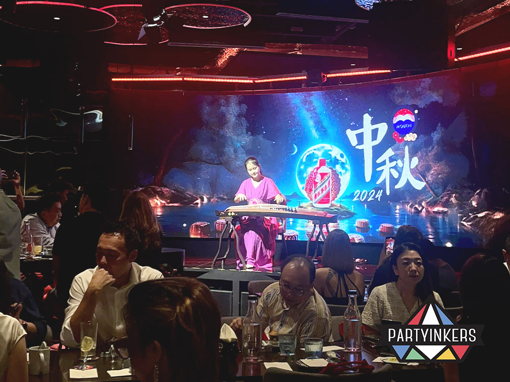 A live musical performance during a Mid-Autumn Festival event, showcasing one of the interactive event ideas where live entertainment engages the audience and enhances the cultural atmosphere of the celebration.