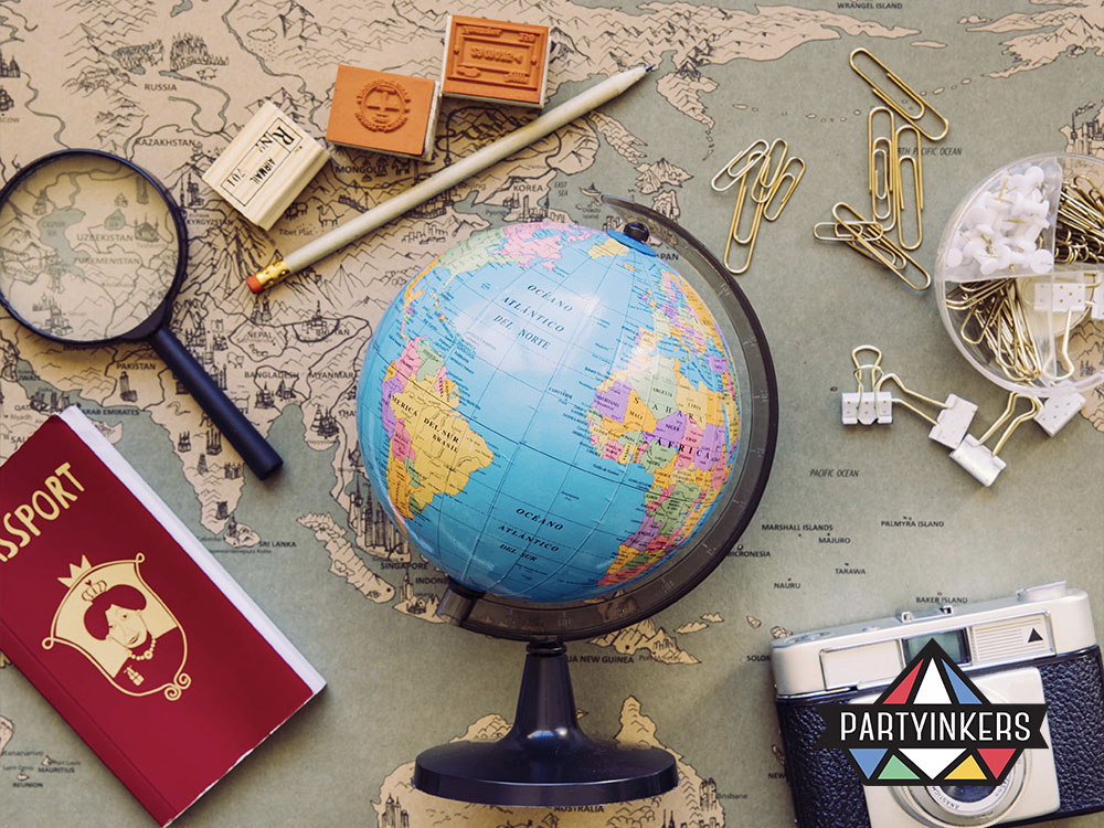 A creative "Around the World" Dinner and Dance theme featuring a globe, map, passport, and travel accessories, ideal for celebrating diversity and global cultures.