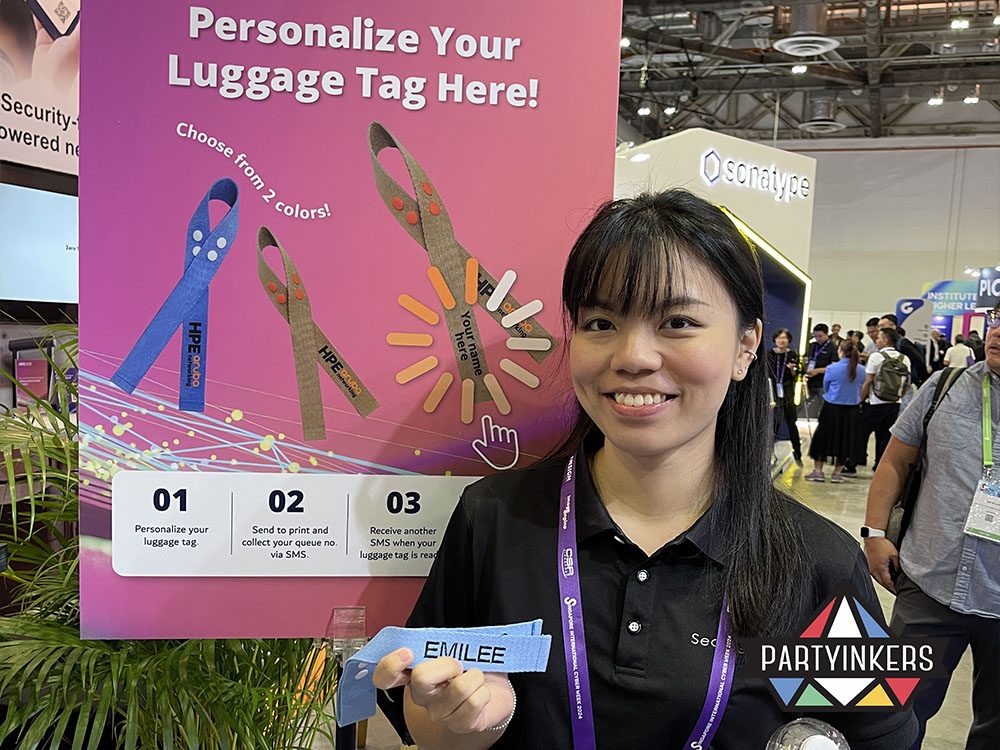 A delighted guest holding a personalized keepsake at a Dinner and Dance theme event, showcasing interactive customization services for a memorable experience.