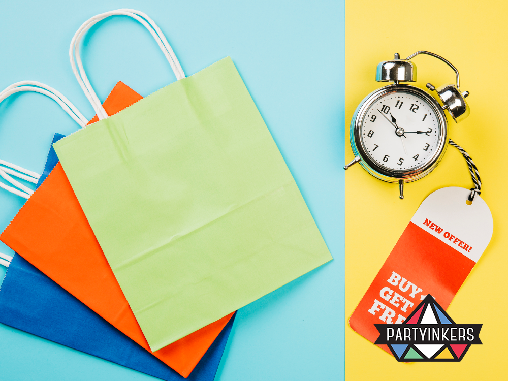 Brightly colored shopping bags with a clock and a "Buy One Get One Free" tag, symbolizing promotional giveaways and time-limited offers at events.