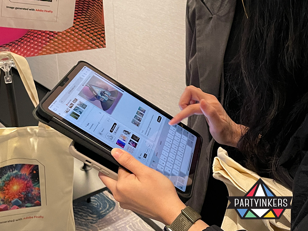 Participant exploring design options on a tablet for personalized tote bag creation with Adobe Firefly during the Adobe Make It event