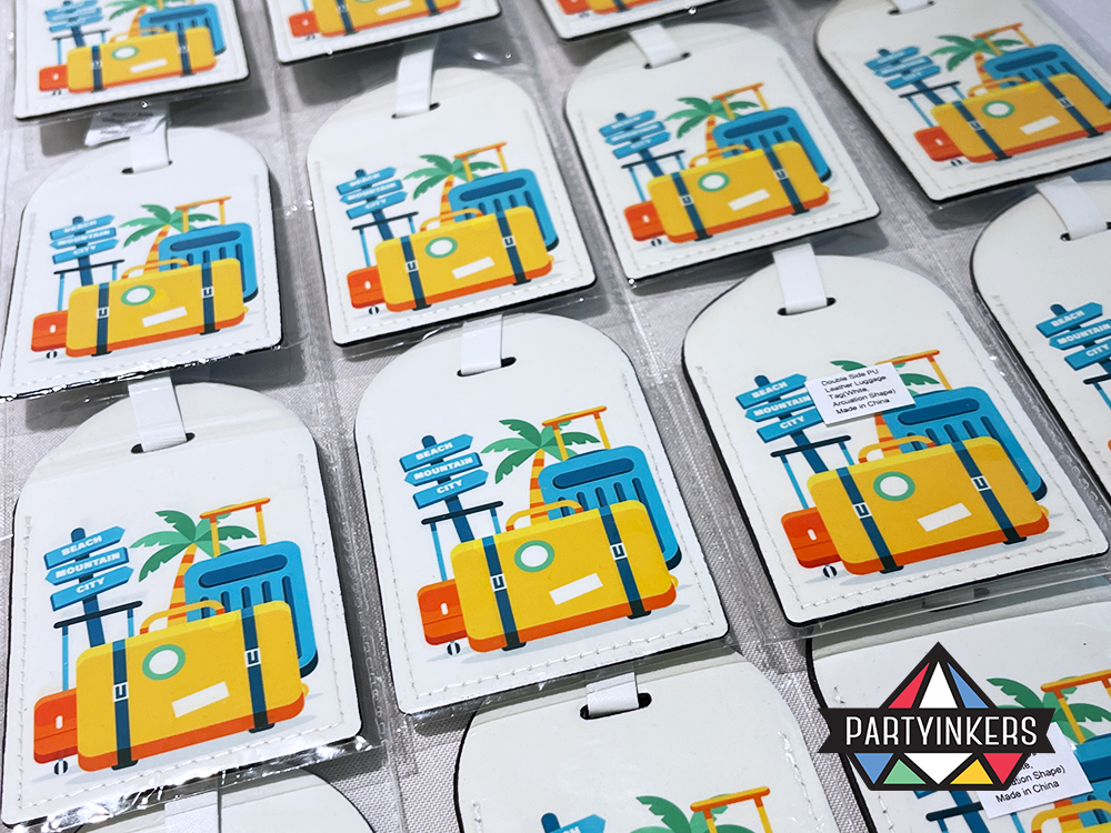 A collection of custom-designed luggage tags created for the Grab event, featuring vibrant travel-inspired graphics and personalized touches.