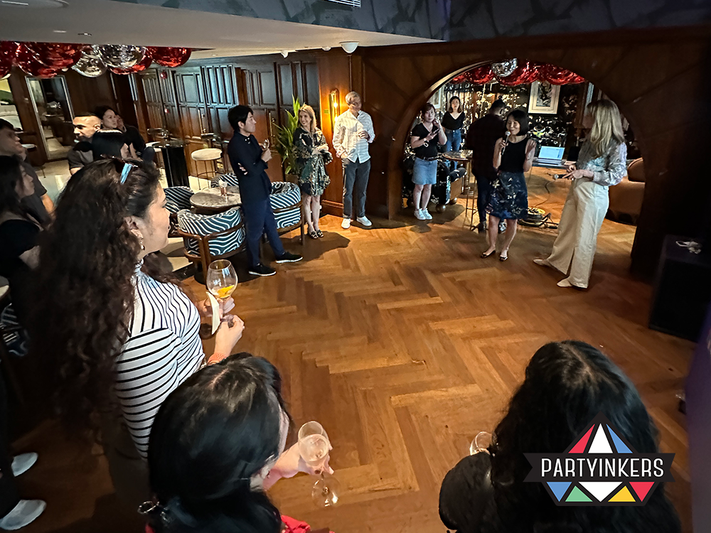 Professionals gather at a LinkedIn networking mixer, held in a luxurious venue designed to facilitate casual yet meaningful interactions among industry leaders. Attendees, with drinks in hand, listen intently to a speaker, illustrating the event's focus on fostering connections, sharing ideas, and uncovering career opportunities in a relaxed and elegant setting.