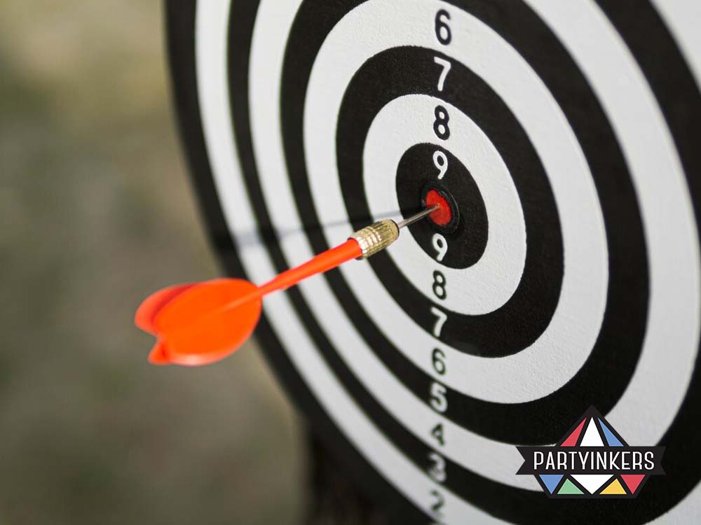 A dart hitting the bullseye on a black and white target board, symbolizing precision, focus, and achievement.