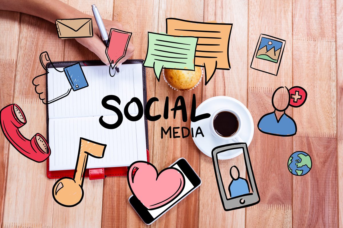 An artistic representation of social media concepts, featuring icons like messages, hearts, and photos surrounding a notebook, a cup of coffee, and a muffin on a wooden desk.