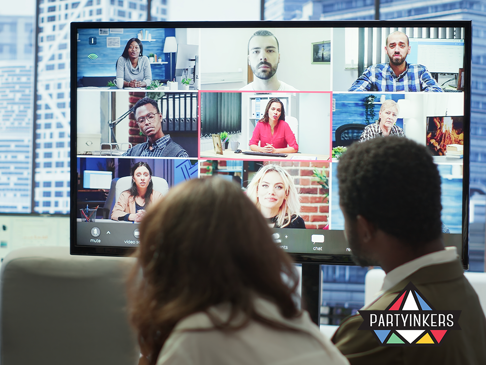 Corporate team attending an interactive virtual webinar, with multiple speakers displayed on a large monitor. This image showcases a diverse panel engaging with remote attendees, reflecting the modern approach to corporate communication and learning through digital platforms.