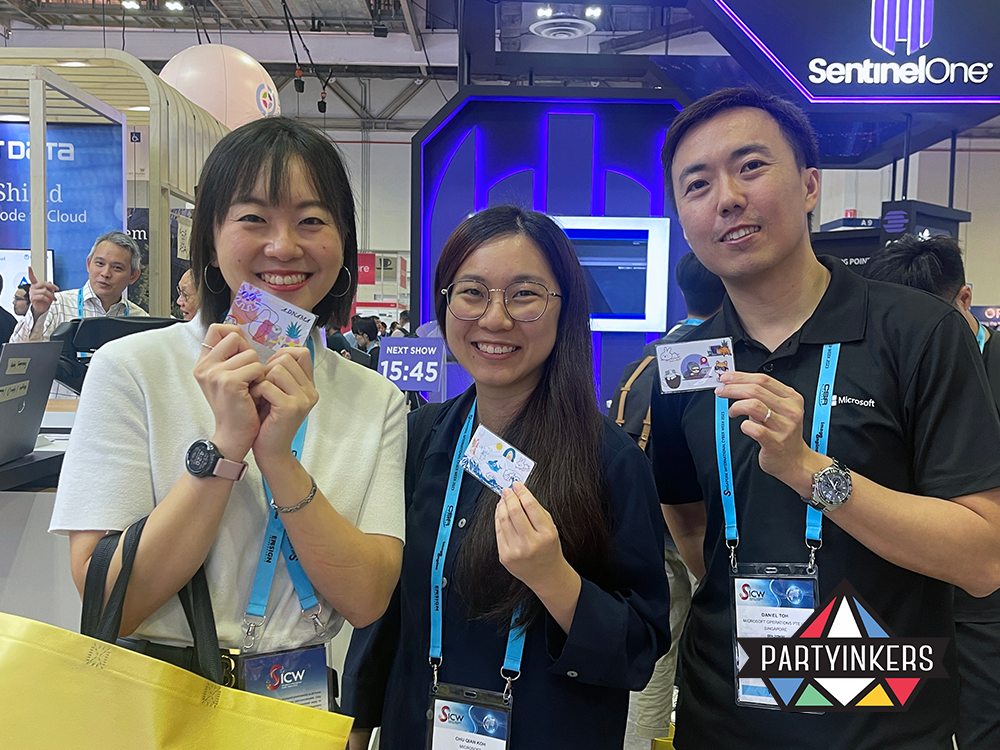 Smiling attendees at a Microsoft event showing off their custom-printed ID cards, demonstrating effective brand activation ideas through personalized giveaways