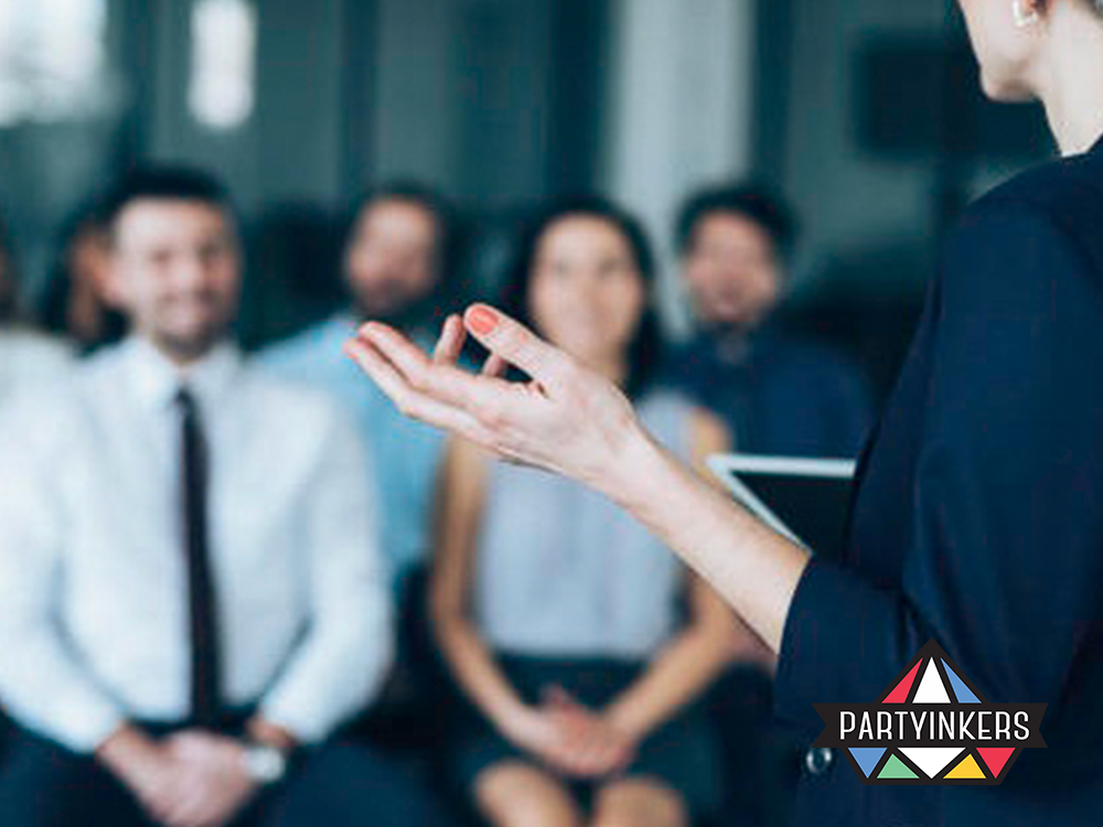 A professional speaker addressing a group of attendees, representing impactful conference entertainment ideas.