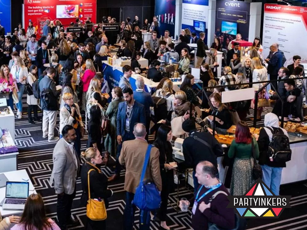 Bustling conference networking area with professionals engaging and exploring interactive exhibition booths, embodying conference entertainment ideas