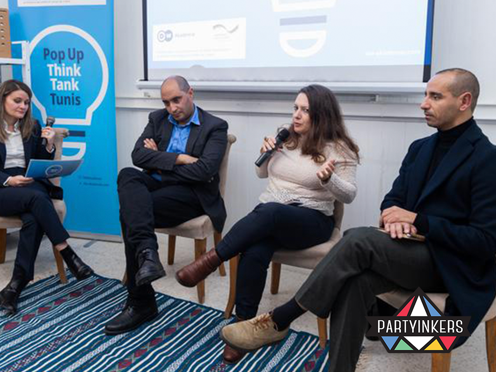 A small group discussion during the Pop Up Think Tank Tunis event, focusing on intellectual discourse and brainstorming as part of conference entertainment ideas.