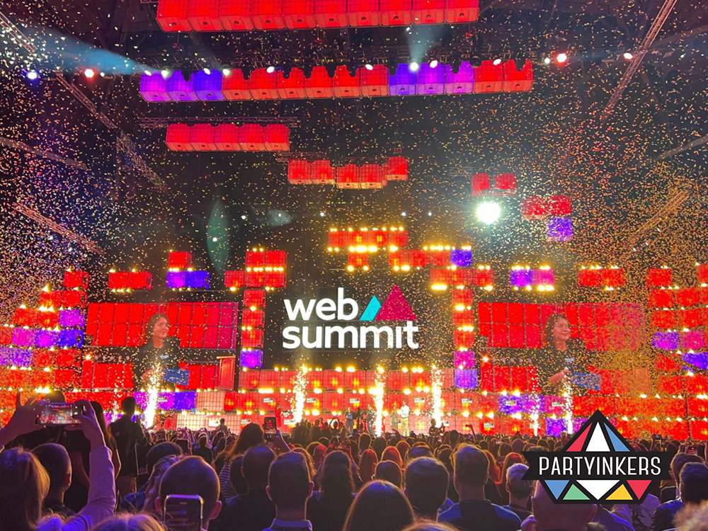  Vibrant stage setup at the Web Summit, featuring stunning visual effects, a perfect example of dynamic conference entertainment ideas.
