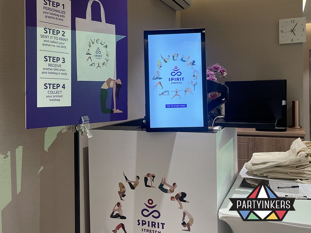 A sleek and minimalistic setup for the "Spirit Stretch" customization booth, featuring branding instructions and design options.