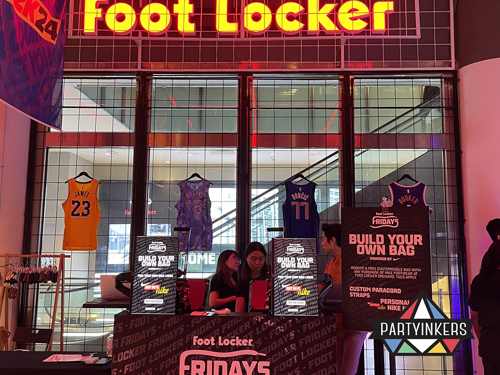 Foot Locker event booth featuring a live 'Build Your Own Bag' customization station powered by Partyinkers.