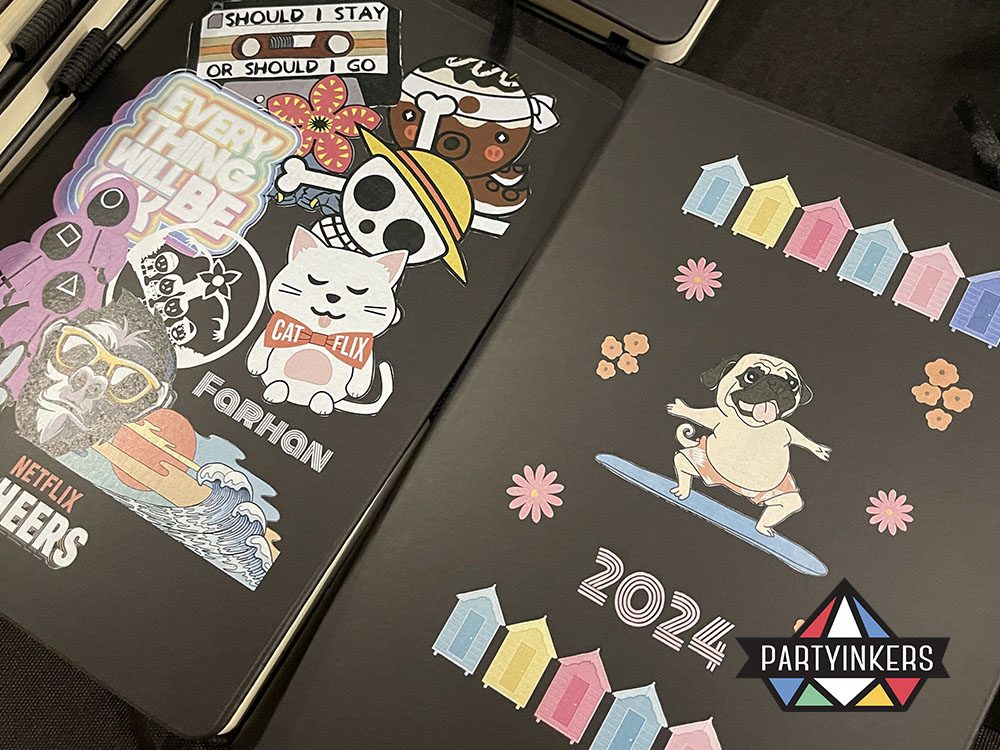 Two customized notebooks adorned with colorful stickers and creative designs, highlighting personalized artwork.