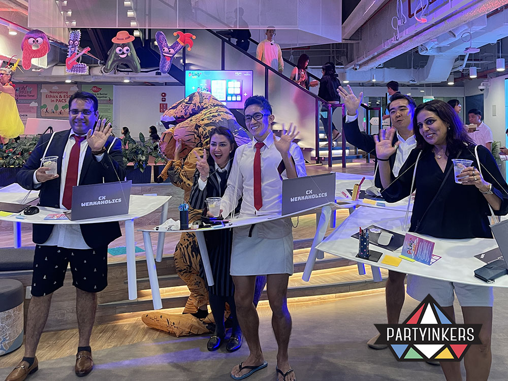 Group of event attendees in fun office-themed costumes enjoying the interactive activities at the event, creating a lively atmosphere.