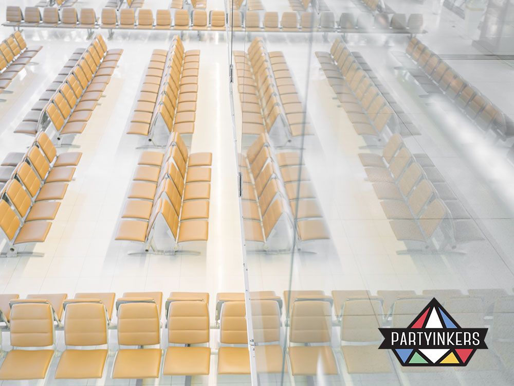 Rows of sleek, yellow chairs in a well-lit and spacious waiting lounge area, emphasizing clean and modern design.