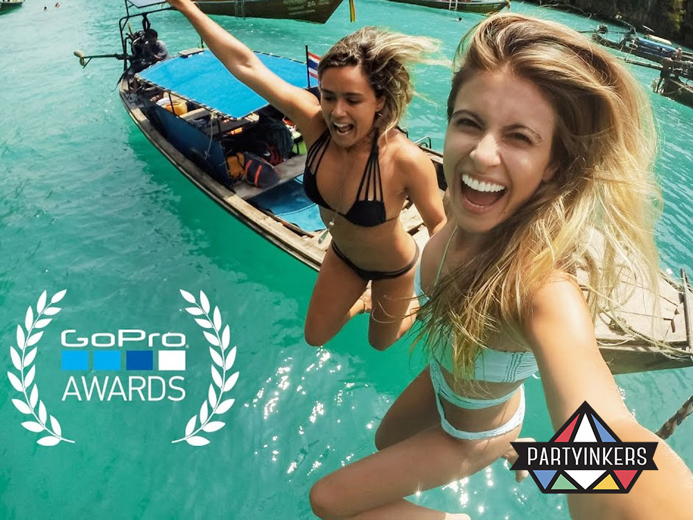 Two women excitedly jumping into the ocean for a GoPro Awards campaign, demonstrating adventurous brand activation ideas through user-generated content.
