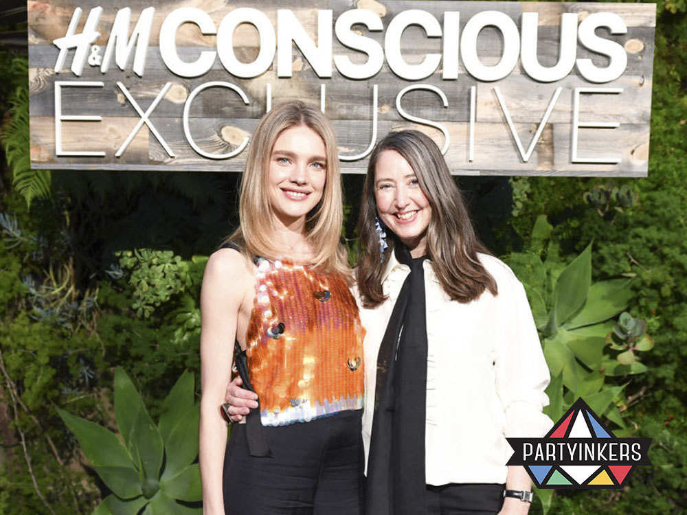 Two women posing at an H&M Conscious Exclusive event, a creative brand activation idea promoting eco-friendly fashion through immersive brand storytelling.