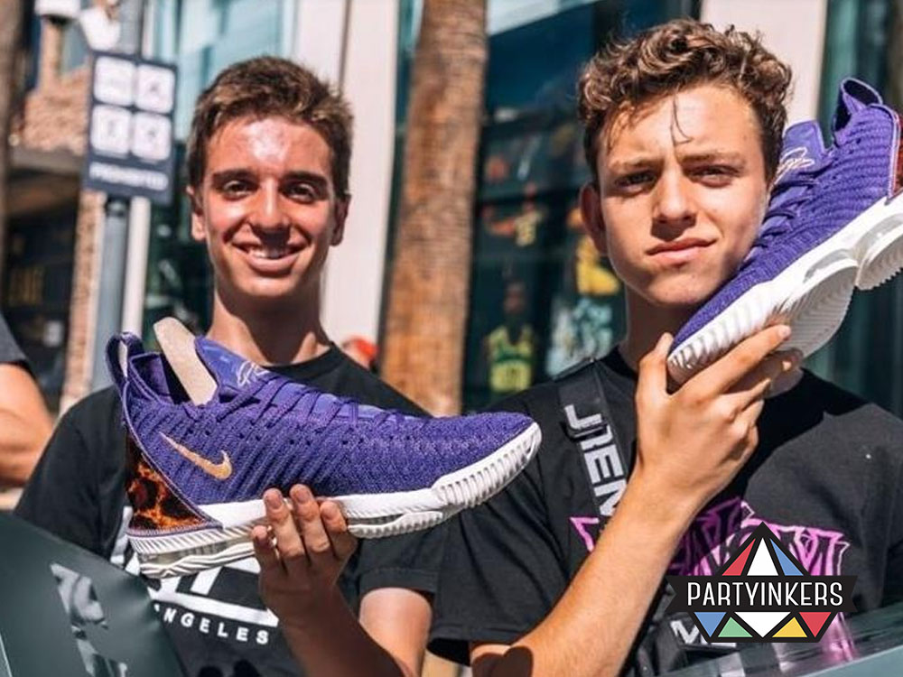 Two young men proudly displaying their new Nike sneakers at an outdoor activation event, illustrating an impactful brand activation idea that fosters brand loyalty and engagement.