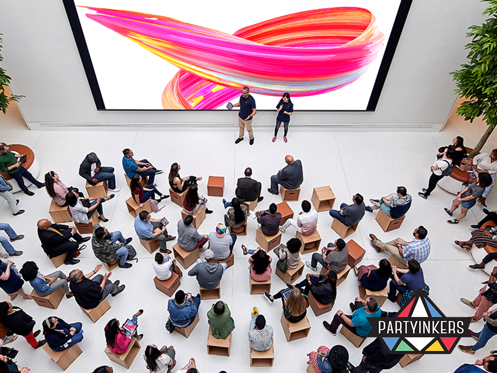 A group of people attending a hands-on creative workshop at an Apple store, highlighting brand activation ideas that drive community involvement and experiential learning.