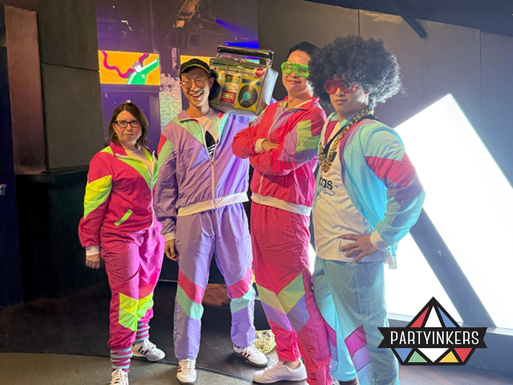 Employees dressed in colorful retro outfits for a themed corporate party with 80s-inspired vibes that present memorable company event ideas.