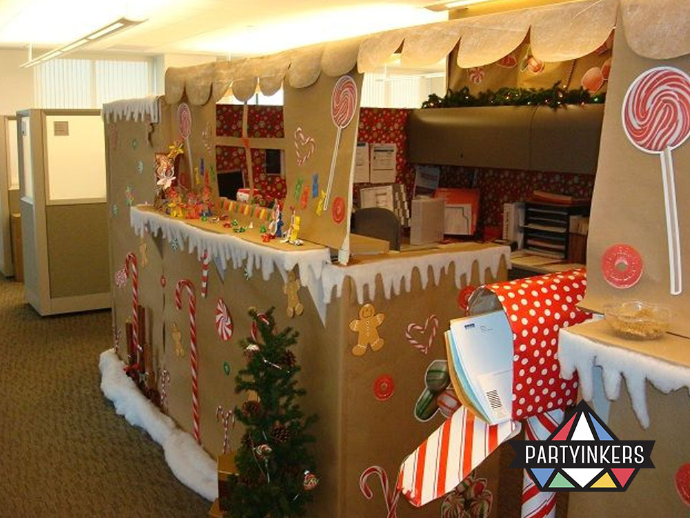 Office cubicle decorated as a gingerbread house as part of in-office corporate event ideas for a holiday-themed contest.