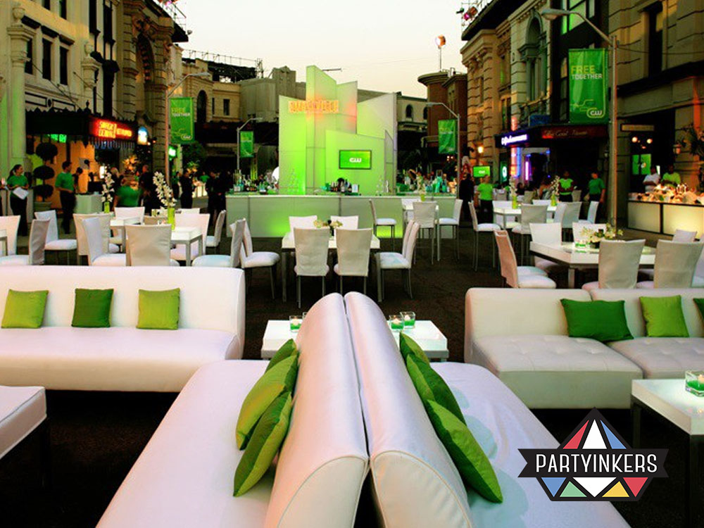 Eco-friendly outdoor setup showcasing sustainable corporate event ideas with reusable furniture and a green theme.