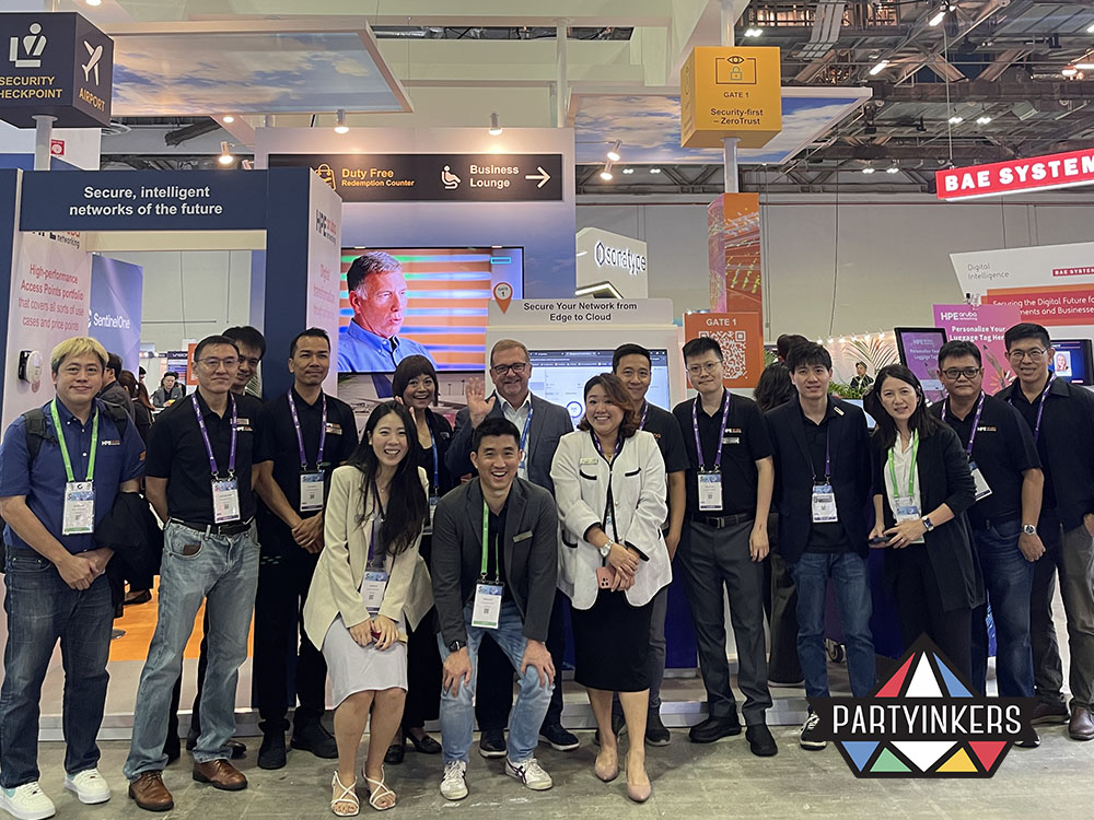 Corporate team at a tech booth using trade show booth strategies to boost visibility and support lead generation at trade shows.