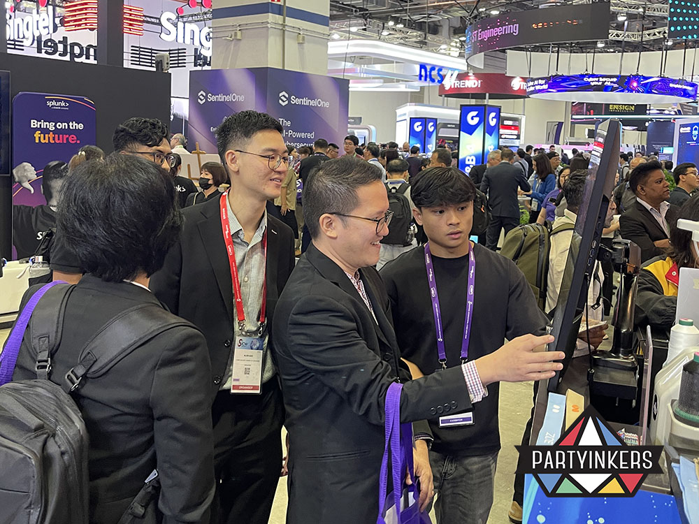 Attendees using an interactive station for onsite customization, demonstrating experiential lead capture at trade shows by Partyinkers.