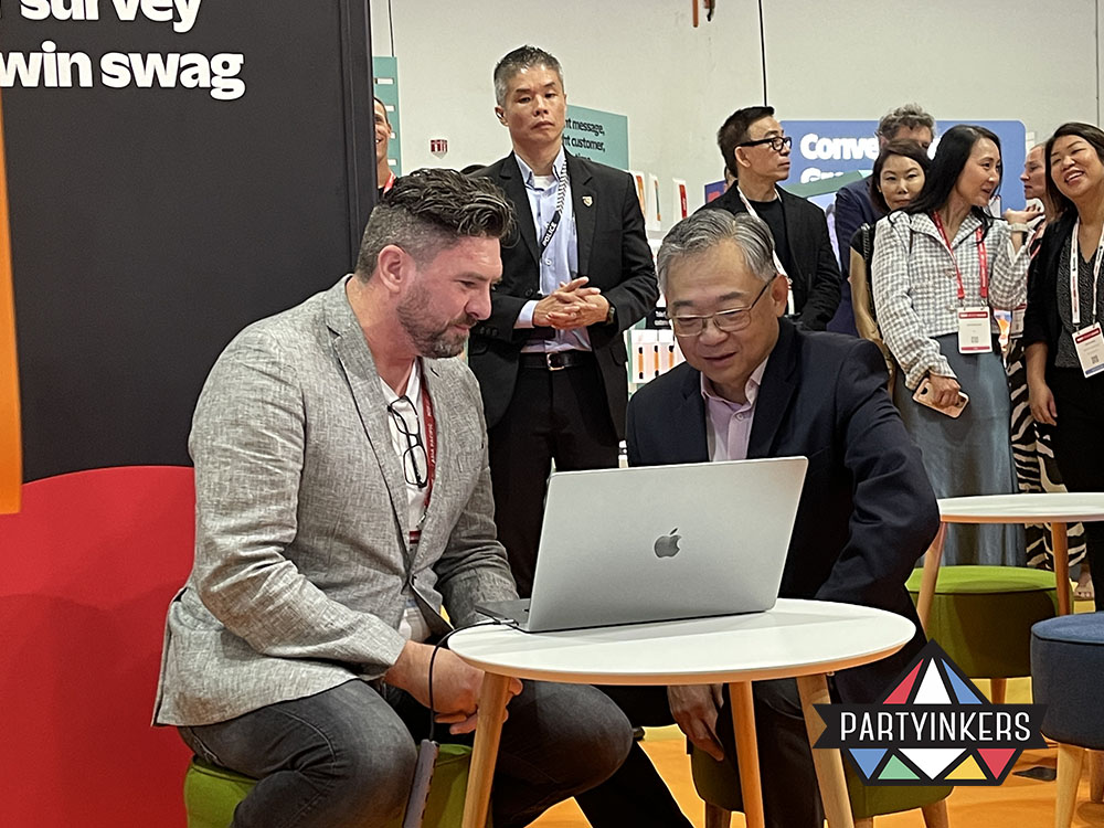 Trade show engagement ideas in action as attendees connect over digital presentations, supporting lead generation at trade shows.